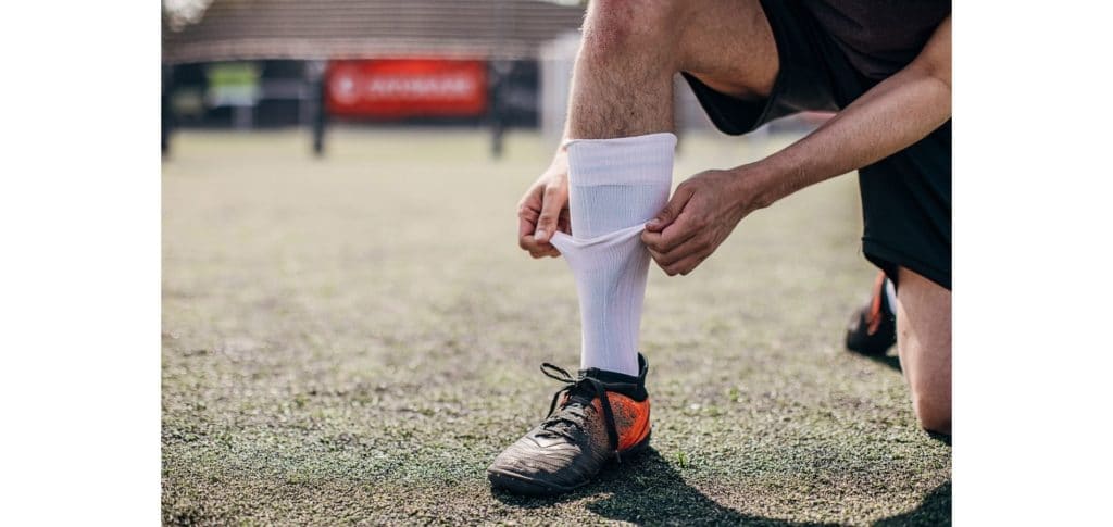 playing soccer in the rain - wear long socks