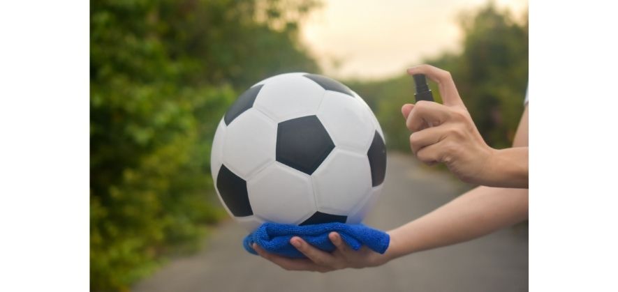how to clean a soccer ball - use a damp cloth to wipe the ball surface