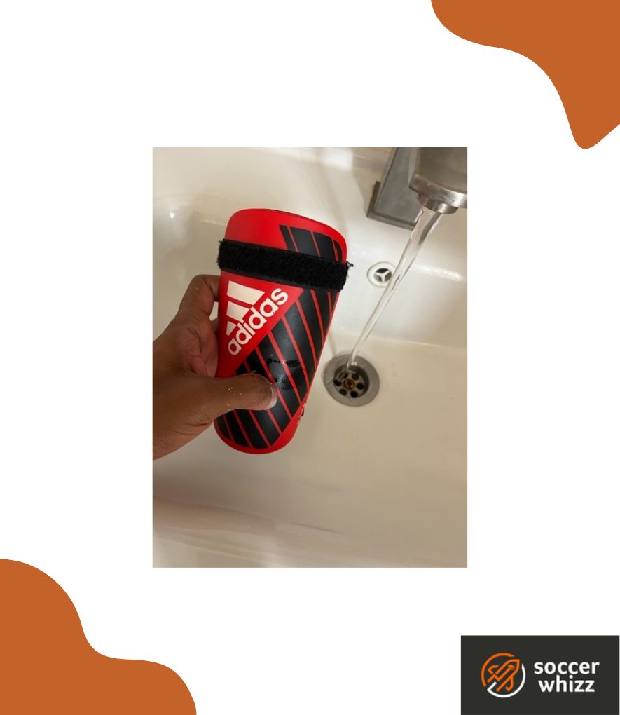 how to clean soccer shin guards - rinse under tap water